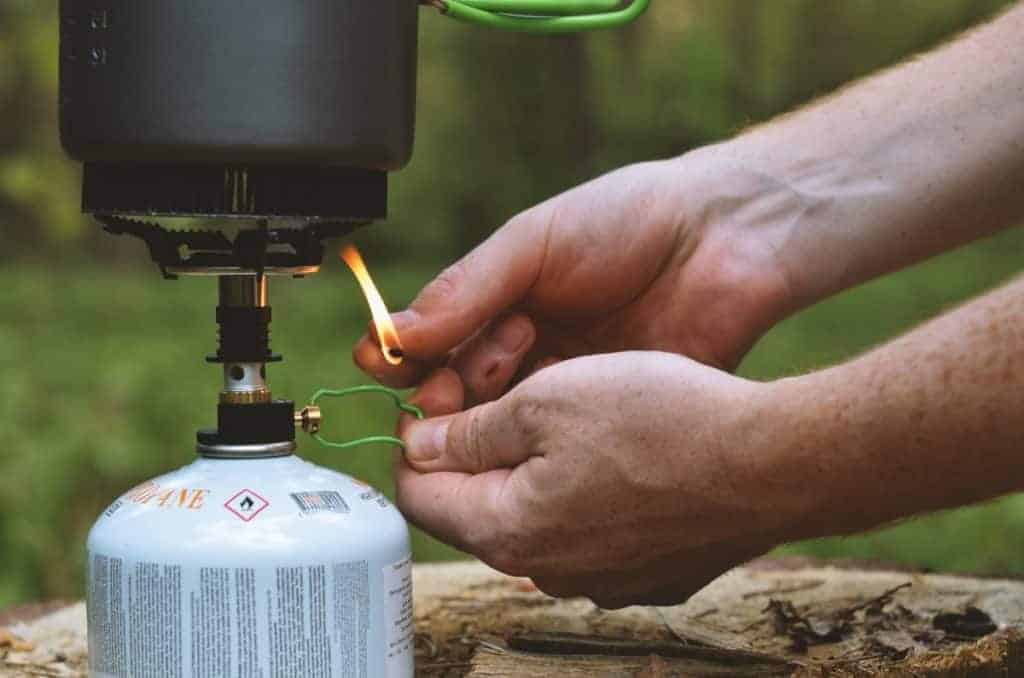Man lighting a portable emergency stove