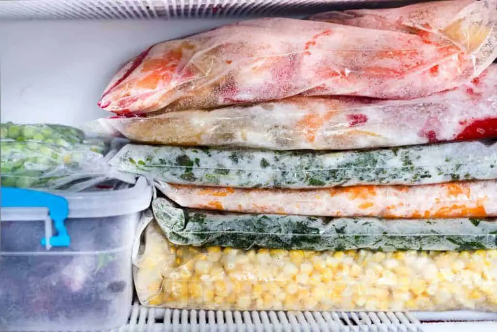 Frozen survival food: packs of vegetables in a freezer